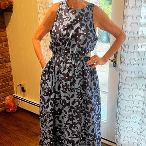 blue floral sleeveless cotton dress with small side cutouts. Brand new